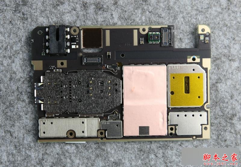 主板背部也是布满了屏蔽罩，也可以看到一块铜箔片，下方是SoC和闪存芯片，用于给这两个发热大户传导热量。